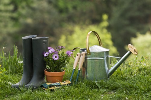 Professional gardener working in a Hackney terrace garden, preparing ground for landscaping